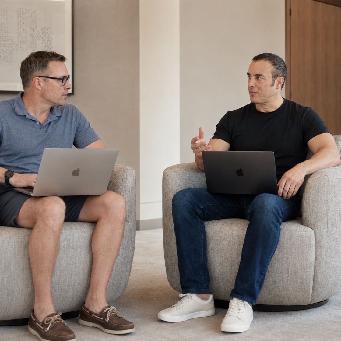 Chris Guerriero working one-on-one with a founder, laptops open, in his Wellington office